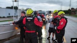 This photo provided by Iowa's Sioux City Fire Rescue shows Sioux City Fire Rescue's Urban Search and Rescue team assists in evacuations due to a breached levy June 22, 2024. A railway bridge collapsed near the city due to flooding June 24, 2024.