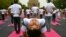 People take part in a yoga session at Lodhi gardens on International Day of Yoga, in New Delhi.