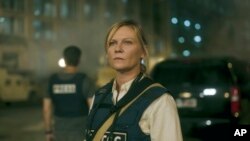 This image released by A24 shows Kirsten Dunst in a scene from 'Civil War'. (A24 via AP)