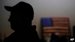 Earl Meyer, who fought for the US Army in the Korean War, talks with fellow veterans at the American Legion, Nov. 7, 2023, in St. Peter, Minn.