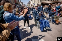 US veterans parade during a gathering in preparation of the 79th D-Day anniversary in Sainte-Mere-Eglise, Normandy, France, June 4, 2023.