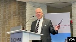 美国国会共和党籍阿拉斯加州联邦参议员丹·沙利文手举《为何台湾重要》手册。（2023年7月18日，美国之音锺辰芳拍摄）