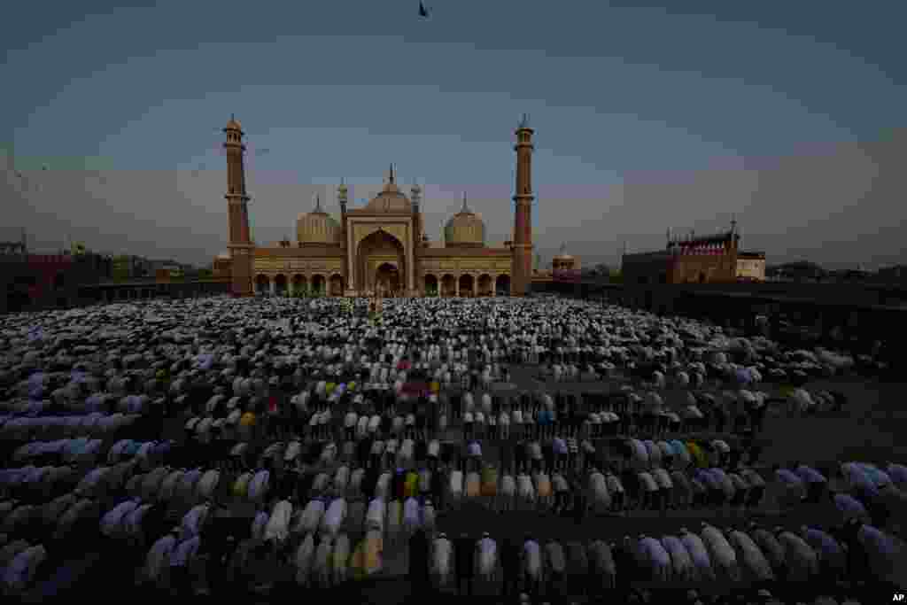 Devout Muslims offer Eid al-Adha prayers at the Jama Masjid, in New Delhi, India.