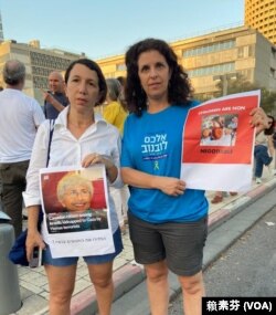 加拿大籍以色列人质维维安·西尔弗的朋友诺亚·特格曼 (Noa Turgeman 左) 手拿海报在“人质广场”上表达对维维安的支持。（赖素芬拍摄）