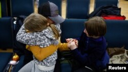 从白俄罗斯边境回到乌克兰的乌克兰女童和哥哥在基辅与家人团聚。（2023年4月8日）