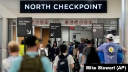 Travelers move through Hartsfield-Jackson Atlanta International Airport ahead of Memorial Day, May 24, 2024, in Atlanta.