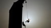 Silhouettes of climbers hanging on ropes after competing in the women's speed sport climbing qualification at the 2024 Olympic Qualifier Series held in Budapest, Hungary, June 22, 2024.