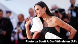 Demi Moore poses for photographers upon arrival at the awards ceremony during the 77th international film festival, Cannes, southern France, May 25, 2024.
