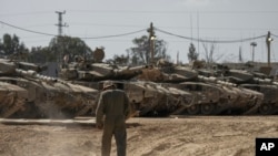 2024年4月11日，以色列士兵在以色列南部加沙走廊邊境附近的一個集結地修理坦克。