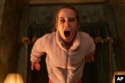 This image released by Universal Pictures shows Alisha Weir in a scene from the film 'Abigail'. (Bernard Walsh/Universal Pictures via AP)