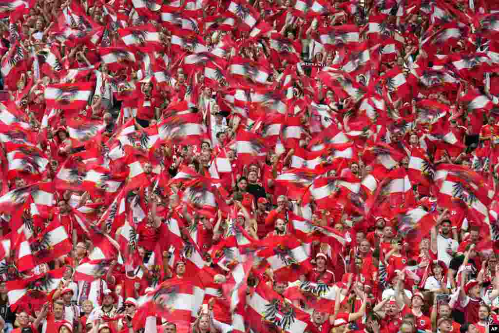 Austrian fans cheer for their national team before a Group D match between Poland and Austria at the Euro 2024 soccer tournament in Berlin.