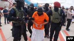 Indonesian police escort Zulkarnaen of Jemaah Islamiyah, wanted for his alleged role in the 2002 Bali bombings, in Tangerang, Dec. 16, 2020. Two suspected militants killed by police April 12, 2023, had been accused of once harboring Zulkarnaen.