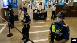 Police officers cordon off the scene near a subway station in Seongnam, South Korea, Aug. 3, 2023.
