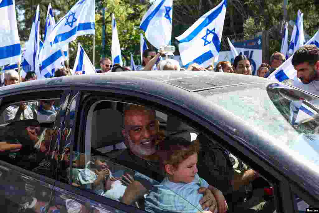 Shlomi Ziv, who was kidnapped in the deadly October 7 attack by Hamas and is one of four hostages who has been rescued by Israeli forces alive, looks on from a vehicle as he returns home from the hospital, in Elkosh in northern Israel.