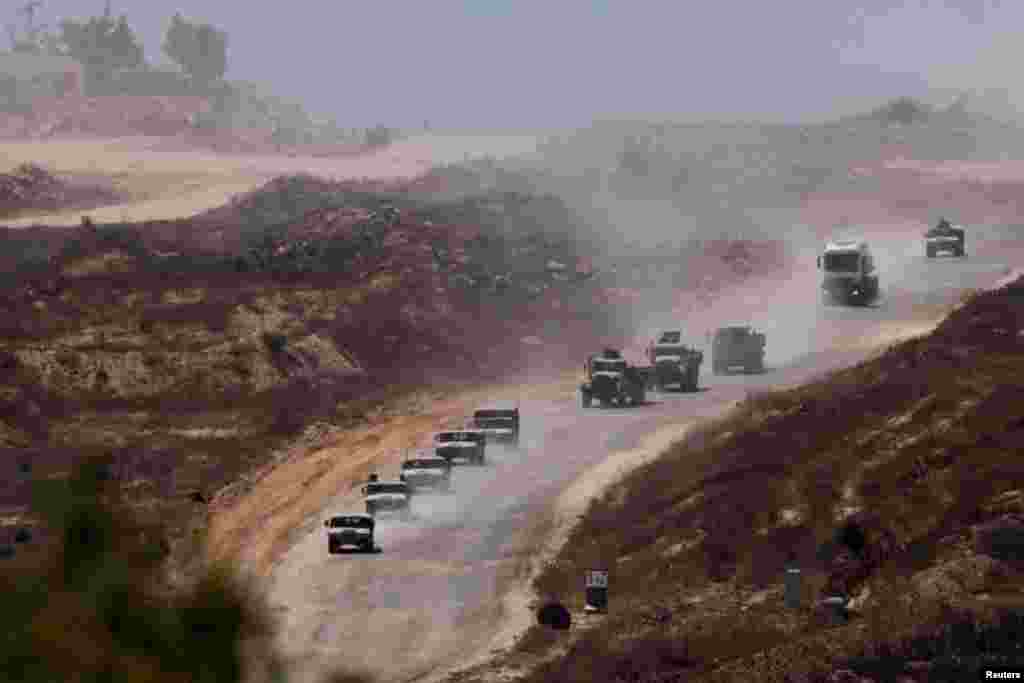 An Israeli military convoy moves inside the Gaza Strip, amid the ongoing conflict between Israel and Hamas, as seen from Israel.