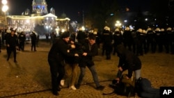Protesters are detained by plain clothes police during a rally against what election observers said were widespread vote irregularities during a general election a week ago, in downtown Belgrade, Serbia, Dec. 24, 2023. 