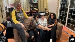 From left, members of the band Seera including Thing, Noura, Hayahuascah and Meesh take a selfie during an interview with The Associated Press in Riyadh, Saudi Arabia, May 12, 2024.