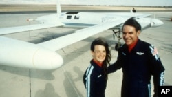 FILE - Co-pilots Dick Rutan, right, and Jeana Yeager pose after a test flight over the Mojave Desert, Dec. 19, 1985. The two completed the first round-the-world flight with no stops or refueling in 1986. Rutan died May 3, 2024.
