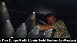 2023年5月19日，在乌克兰前线城镇巴赫穆特附近，一名乌克兰军人站在一辆装载BM-21 Grad多管发射系统的卡车上。