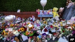 FILE - Flowers and toys are placed on the junction of Tithebarn Road and Hart Street in Southport, England, July 31, 2024, after three girls were killed in a knife attack at a Taylor Swift-themed holiday club earlier in the week. 