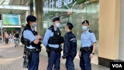 原定3月5日舉行的婦女節遊行取消後，當日下午灣仔街頭到處可見警員巡邏。(美國之音湯惠芸)