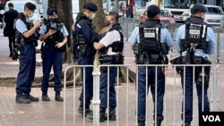 原定3月5日举办的“妇女节游行”宣布取消后，警方仍然在原定的游行起点湾仔修顿球场一带，派出大批身穿防弹战术背心的军装警员巡逻 (美国之音/汤惠芸)