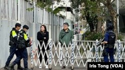 押送李宇軒的囚車進入西九龍裁判法院大樓時，警方暫時封鎖附近的行人路，甚至有荷槍實彈的反恐特勤警員戒備。(美國之音 湯惠芸)