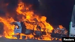 Smoke rises as a truck burns near the Myanmar-China border, near Muse, Myanmar, in this screen grab obtained from a social media video released on Nov. 23, 2023. 