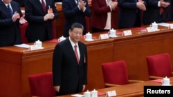 资料照片: 2024年3月11日习近平出席全国人民代表大会闭幕会议