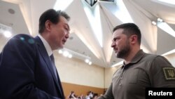 南韓總統尹錫悅與烏克蘭總統澤連斯基2023年5月21日在日本廣島舉行的七國集團會議上握手。
