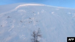 FILE - Members of the CNSAS of Aosta Valley working after an avalanche killed 3 freeriders, and as one person was missing in Canale degli Spagnoli in Courmayeur, Feb. 4, 2019. (AFP photo / Corpo Nazionale Soccorso Alpino e Speleologico (CNSAS))