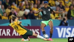 Australia's Katrina Gorry, left, competes for the ball with Nigeria's Rasheedat Ajibade during the Women's World Cup Group B soccer match between Australia and Nigeria in Brisbane, Australia, July 27, 2023.