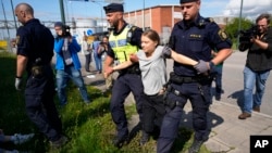 FILE - Climate activist Greta Thunberg is detained by police during an action for blocking the entrance to an oil facility in Malmo, Sweden, July 24, 2023.