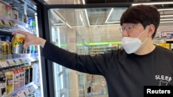 Son In-seok picks up Asahi's new super dry draft canned beer at a convenience store in Seoul, South Korea, May 12, 2023.