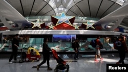 旅客走在北京大興國際機場內的五星裝飾。（2023年4月24日）