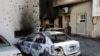 A man looks at a car burned during yesterday's clashes in Tripoli, Libya, Aug. 28, 2022.
