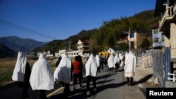 中國浙江桐廬縣的一家人在給剛剛離世的一位親人送葬。 （路透社2023年1月9日照片）