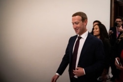 Facebook Chief Executive Mark Zuckerberg walks past members of the news media between meetings with lawmakers on Capitol Hill in Washington, Sept. 19, 2019.