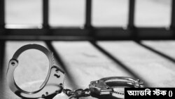 Handcuff and prison bars