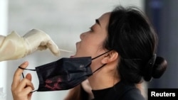 一名上海女子在接受新冠核酸檢測。 （2022年12月7日）