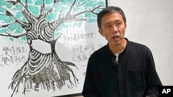 資料照：2021年1月14日，曾在多家香港媒體機構工作的資深記者和教學顧問區家麟在香港的一個電視節目中發表講話。 （美聯社）