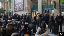 Travelers wait as Eurostar trains to London and all trains heading to northern France were stopped following the discovery of an unexploded bomb dating back to World War II near the tracks, March 7, 2025, at the Gare du Nord station in Paris. 