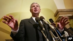 FILE - Then-Senate Intelligence Committee Chairman Sen. Bob Graham, D-Fla., gestures as he answers questions regarding the ongoing security hearing on Capitol Hill, June 18, 2002, in Washington. Graham died April 16, 2024.