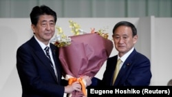 日本首相安倍晉三為在自民黨總裁選舉中獲勝的日本官房長官菅義偉獻花。 （2020年9月14日）