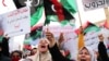 FILE - Libyan women chant slogans during a demonstration to demand an end to the Khalifa Haftar's offensive against Tripoli, in Martyrs' Square in central Tripoli, Libya, April 26, 2019.