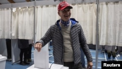 Lars Jorgen Kleist, wearing a MAGA hat, casts his vote during the general election in Nuuk, Greenland, March 11, 2025. 