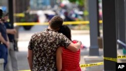 一对新婚夫妇望着伊利诺伊州芝加哥附近海兰帕克枪击惨案的现场。(2022年7月5日)