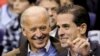 FILE - Then-U.S. Vice President Joe Biden and his son Hunter Biden attend an NCAA basketball game between Georgetown University and Duke University in Washington, Jan. 30, 2010. 