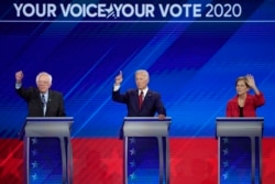FILE - From left, Democratic presidential candidates Sen. Bernie Sanders, I-Vt., former Vice President Joe Biden and Sen. Elizabeth Warren, D-Mass., participate in the debate at Texas Southern University in Houston, Sept. 12, 2019.