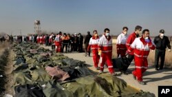 2020年1月8日星期三，救援人員正在運送737-800客機遇難者的遺體。(美聯社) 